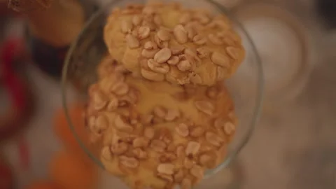 Peanut cookie display. Closeup of nuttopped cookies. Cookies in glass bowl with Stock Footage 346563102
