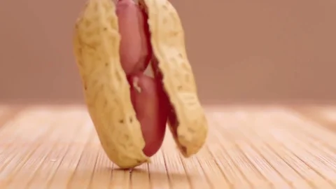 Peanut falling and split in super slow motion Stock Footage 76888452