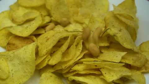 Peanut falling on rotating plate close up. Stock Footage 86575392