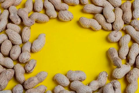 Peanut frame on yellow background, flat lay food Stock Photos