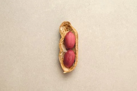 Peanut in its shell resting on a smooth surface, showcasing natural beauty Stock Photos