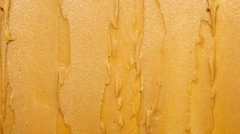 Peanut paste texture top view.Peanut butter cream for spreading. Stock Photos