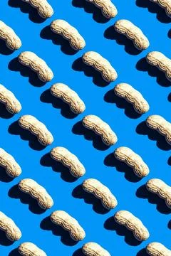 Peanut pattern on blue background, top view colorful food flat lay texture 스톡 사진