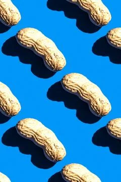 Peanut pattern on blue background, top view colorful food flat lay texture 库存照片