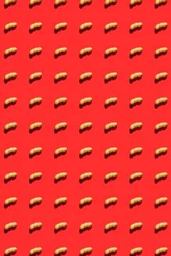 Peanut pattern with shell on red background, colorful flat lay food texture.. Stock Photos