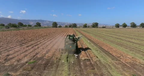 Peanut picker processing a field, Aerial follow footage Stock Footage 219776605