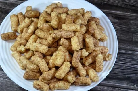 Peanut Puffcorn or corn puffs are puffed or extruded corn snacks made with .. Stock Photos