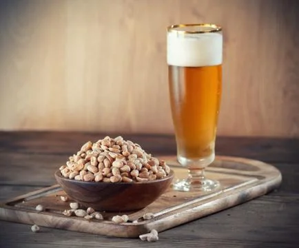 Peanuts and beer Stock Photos