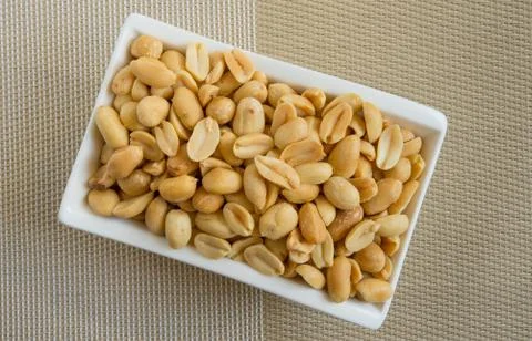 Peanuts and rosemary on texture Stock Photos