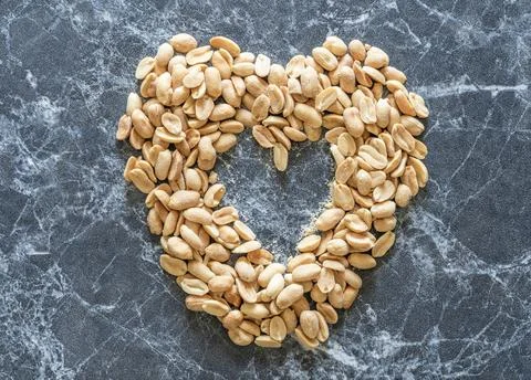 Peanuts arranged in a heart shape Stock Photos