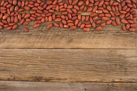 Peanuts on the background of the old wooden table. Stock Photos