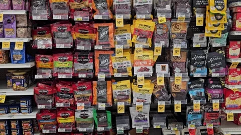 Peanuts, beef jerky, microwave popcorn grocery aisle Video stock 252706733