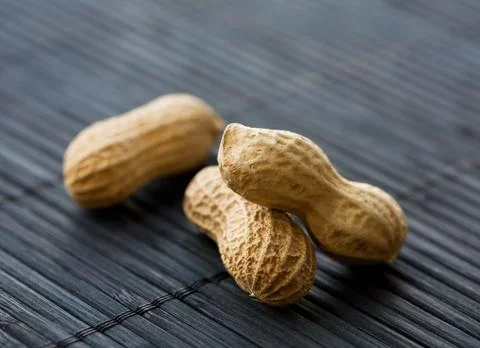 Peanuts on black, close-up Stock Photos