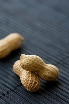 Peanuts on black, close-up Stock Photos