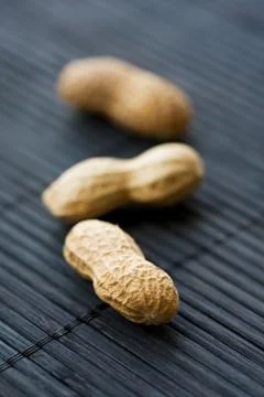 Peanuts on black, close-up Stock Photos