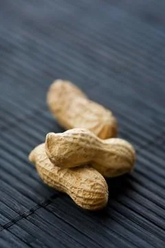 Peanuts on black, close-up Stock Photos