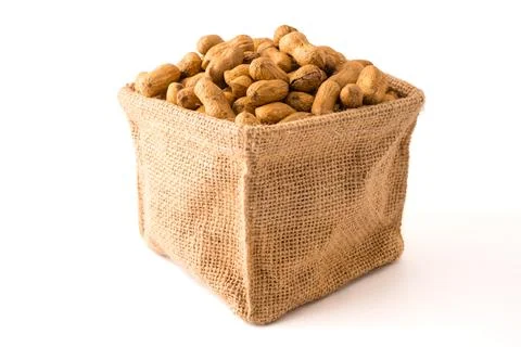 Peanuts in burlap bag on white background. Stock Photos