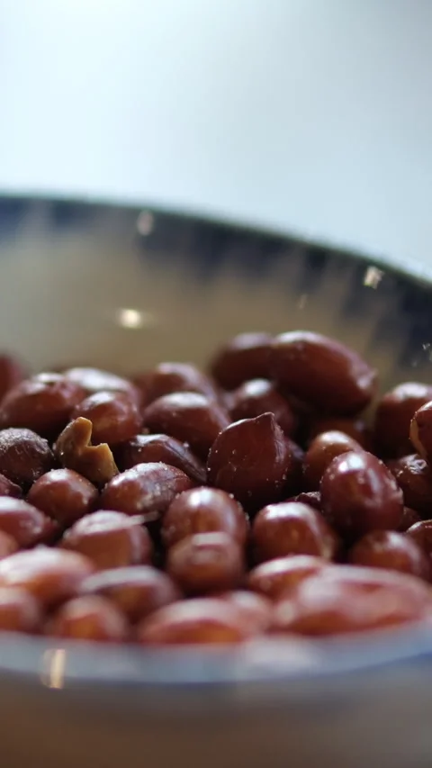 Peanuts ceramic bowl Delicious nutritious peanut in ceramic bowl on dark Stock Footage 310428180