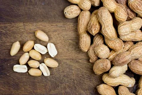 Peanuts on chopping board Stock Photos