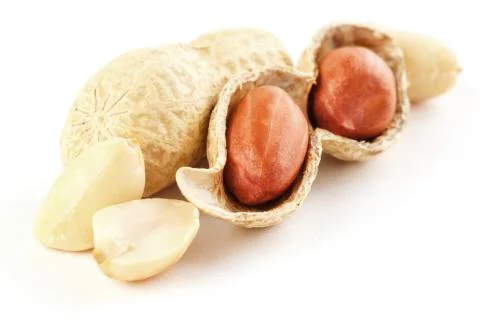 Peanuts closeup in shell and peeled on a white background Stock Photos