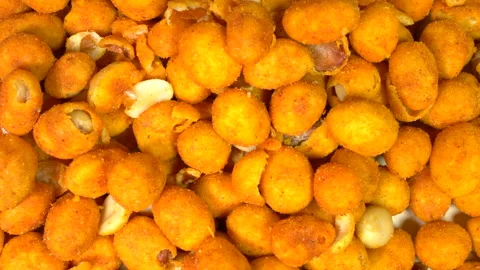Peanuts with a crispy shell coating, pouring into a dish. Stock Footage 171386024