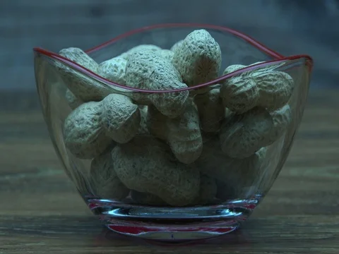 Peanuts fall into glass bowl 스톡 동영상 80277422