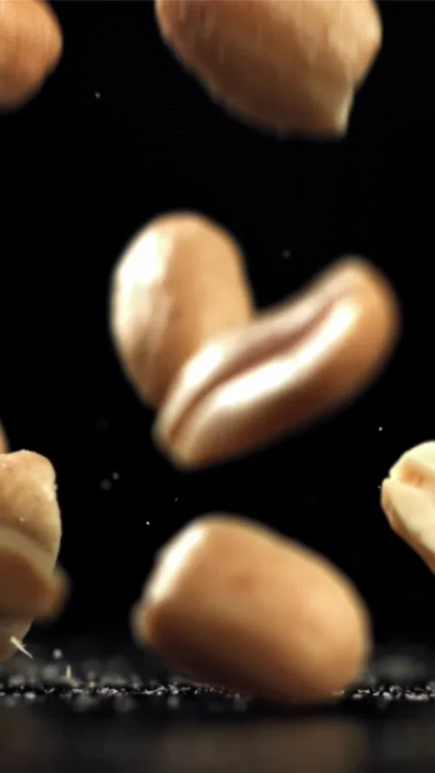 Peanuts fall on the table. Filmed on a high-speed camera at 1000 fps Stock Footage 335307314