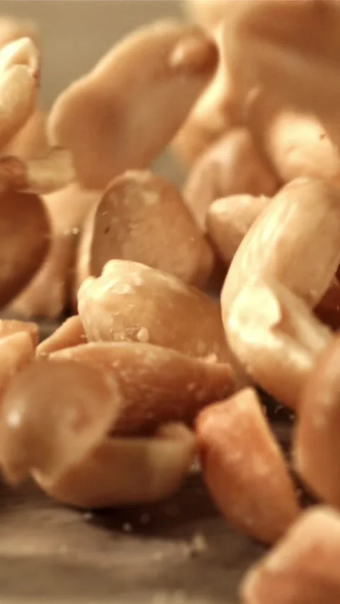 Peanuts fall on the table. Filmed on a high-speed camera at 1000 fps Stock Footage 335315806