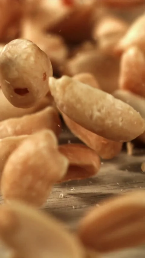 Peanuts fall on the table. Filmed on a high-speed camera at 1000 fps Stock Footage 335323126