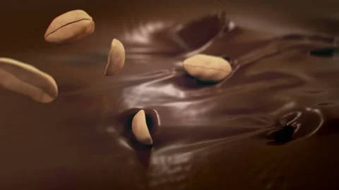 Peanuts Falling Into Liquid Chocolate in 4K Super slow motion Stock-Footage 143464613