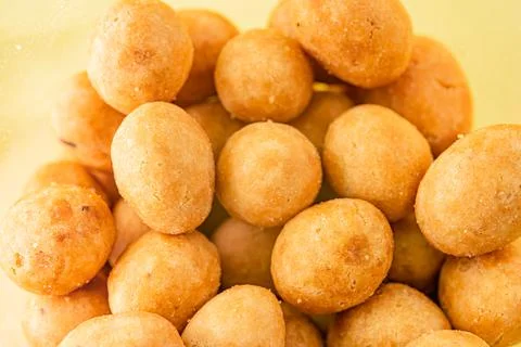 Peanuts in glaze on yellow background Stock Photos