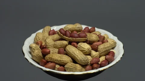 Peanuts. Mixed Peanuts in rotation. Snack closeup. Selective focus. Stock Footage 102281390