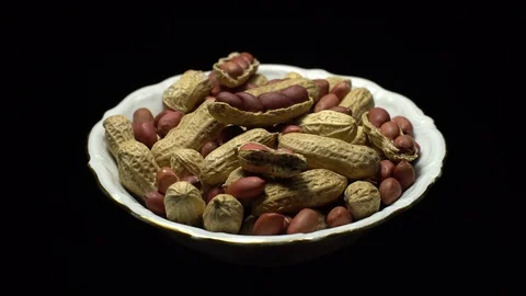 Peanuts. Mixed Peanuts in rotation. Snack closeup. black background. Stock Footage 102282028