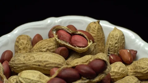 Peanuts. Mixed Peanuts in rotation. Snack closeup. black background. Stock Footage 102282182