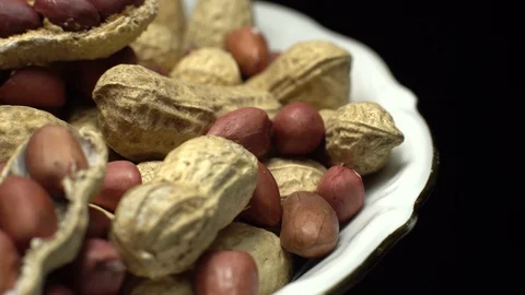 Peanuts. Mixed Peanuts in rotation. Snack closeup. black background. Stock Footage 102282403