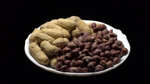 Peanuts. Mixed Peanuts in rotation. Snack closeup. black background. Stock Footage 102290741