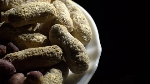 Peanuts. Mixed Peanuts in rotation. Snack closeup. black background. Stock Footage 102290745