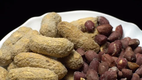Peanuts. Mixed Peanuts in rotation. Snack closeup. black background. Stock Footage 102290764