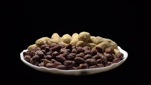 Peanuts. Mixed Peanuts in rotation. Snack closeup. black background. Stock Footage 102290780