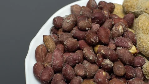Peanuts. Mixed Peanuts in rotation. Snack closeup. Selective focus. Stock Footage 102291395