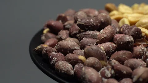 Peanuts. Mixed Peanuts in rotation. Snack closeup. Selective focus. Stock Footage 102291541