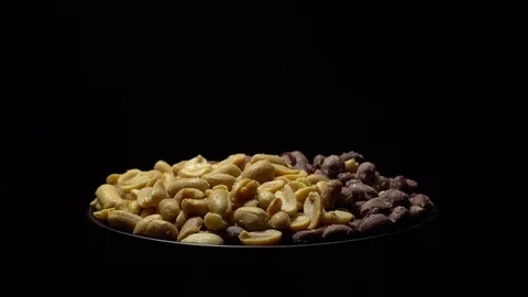 Peanuts. Mixed Peanuts in rotation. Snack closeup. black background. Stock Footage 102291557