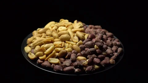 Peanuts. Mixed Peanuts in rotation. Snack closeup. black background. Stock Footage 102291668