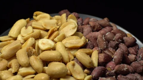 Peanuts. Mixed Peanuts in rotation. Snack closeup. black background. Stock Footage 102291669