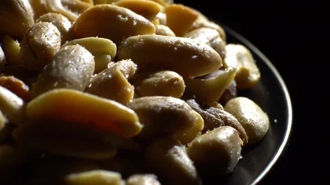 Peanuts. Mixed Peanuts in rotation. Snack closeup. black background. Stock Footage 102291754