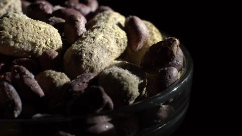 Peanuts. Mixed Peanuts in rotation. Snack closeup. black background. Stock Footage 102337162