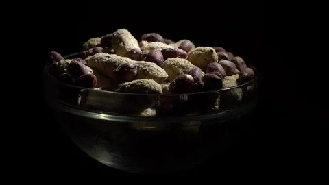 Peanuts. Mixed Peanuts in rotation. Snack closeup. black background. Stock Footage 102337169