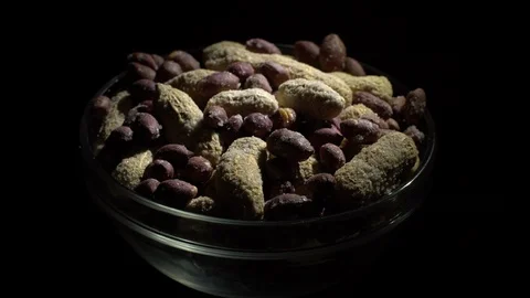 Peanuts. Mixed Peanuts in rotation. Snack closeup. black background. Stock Footage 102337777