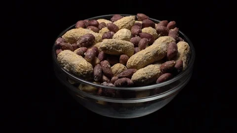 Peanuts. Mixed Peanuts in rotation. Snack closeup. black background. Stock Footage 102338262