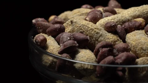 Peanuts. Mixed Peanuts in rotation. Snack closeup. black background. Stock Footage 102338433